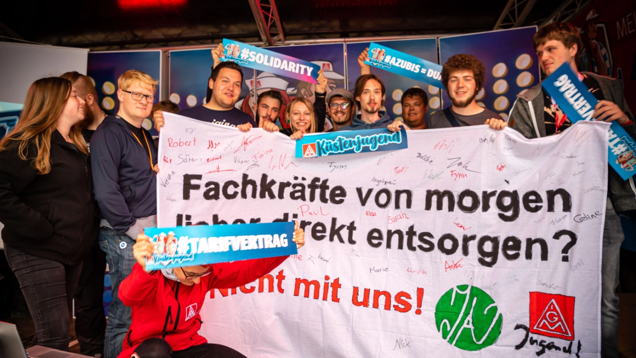 Ein Gruppe hält ein selbst gemaltes Transparent hoch mit der Aufschrift: Fachkräfte für morgen lieber direkt entsorgen?